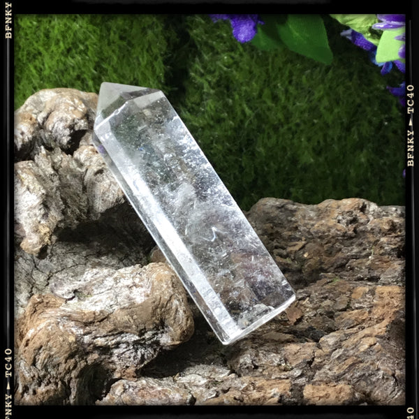 single clear quartz generator on wood