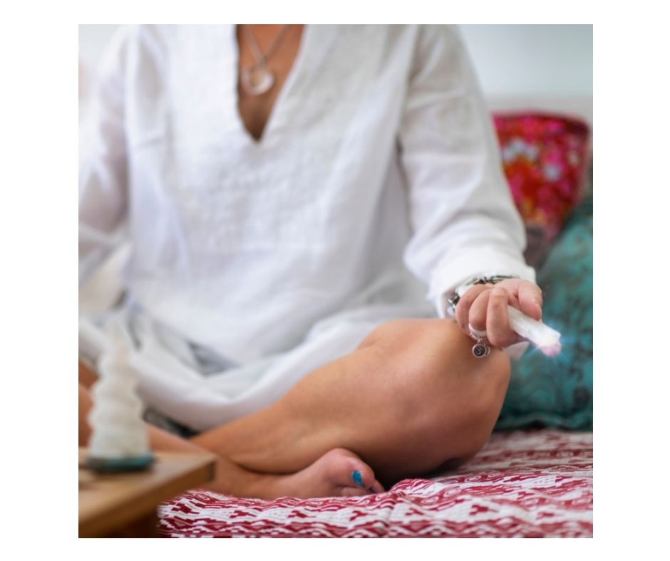crystal held in hand of meditating lady
