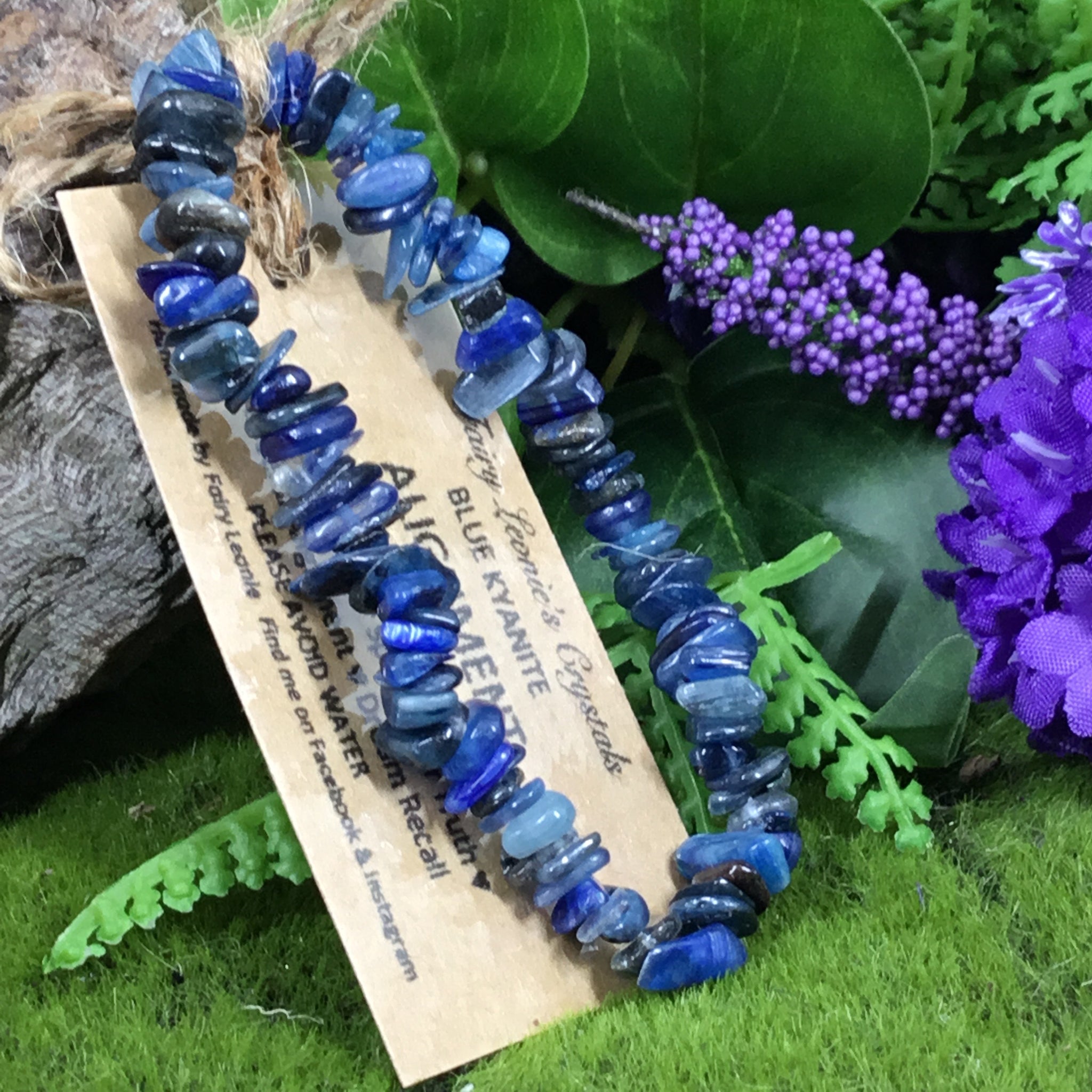 blue kyanite chip beaded bracelet with woodland background and purple flowers